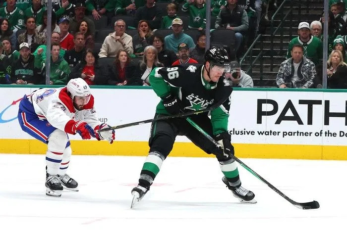  Mikko Rantanen of the Dallas Stars skates with the puck as Phillip Danault of the Montreal Canadiens defends during the third period at American Airlines Center on Sunday, January 4, 2026 in Dallas, Texas.
