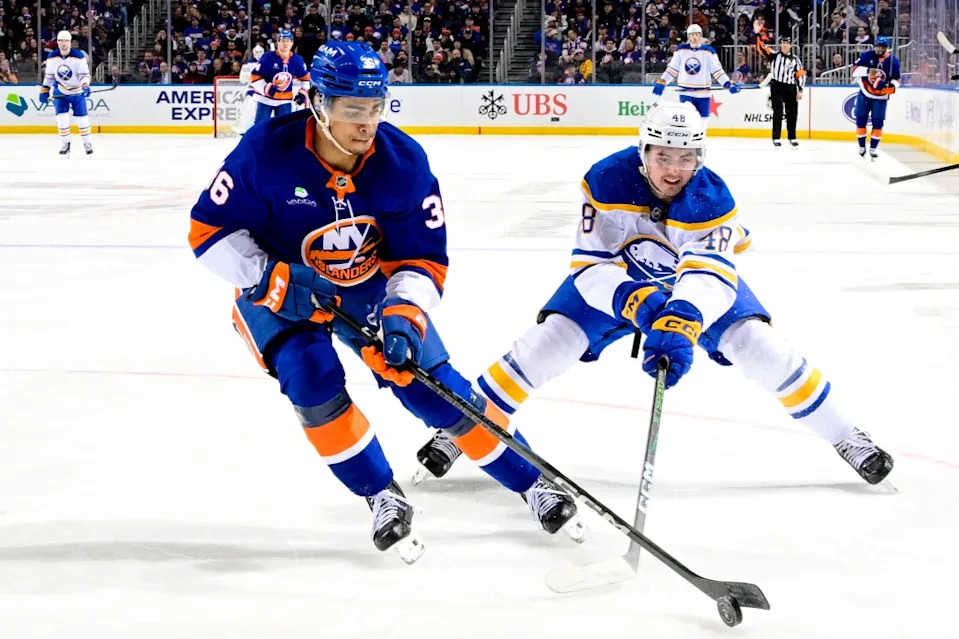 Isaiah George (left) looks to keep the puck away from Tyson Kozak during the second period of the Islanders’ 5-0 loss to the Sabres at UBS Arena on Jan. 24, 2026. NHLI via Getty Images