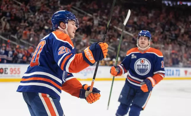 Edmonton Oilers' Curtis Lazar (20) and Mattias Janmark (13) celebrate a goal against the Nashville Predators during second period NHL action, in Edmonton, Tuesday, Jan. 6, 2026. (Jason Franson/The Canadian Press via AP)