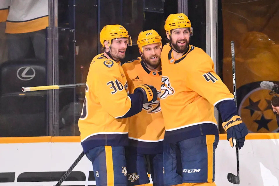 Jan 8, 2026; Nashville, Tennessee, USA; Nashville Predators center Ryan O'Reilly (90) celebrates with his teammates after scoring a goal against the New York Islanders during the second period at Bridgestone Arena. Mandatory Credit: Steve Roberts-Imagn Images