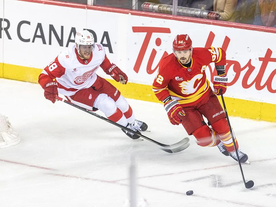  Flames defenceman MacKenzie Weegar carries the puck against the Detroit Red Wings on Dec. 10, 2025.