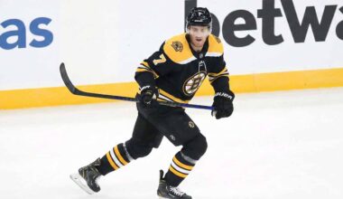 Boston Bruins defenseman Dougie Hamilton, wearing the number 7 black home jersey, skates across the ice holding his stick and looking forward with a focused expression during a game.
