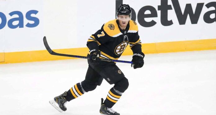 Boston Bruins defenseman Dougie Hamilton, wearing the number 7 black home jersey, skates across the ice holding his stick and looking forward with a focused expression during a game.
