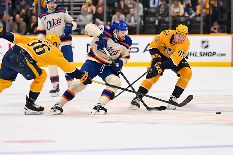 Jan 13, 2026; Nashville, Tennessee, USA; Edmonton Oilers center Leon Draisaitl (29) skates past Nashville Predators left wing Cole Smith (36) and left wing Reid Schaefer (49) during the second period at Bridgestone Arena. Mandatory Credit: Steve Roberts-Imagn Images