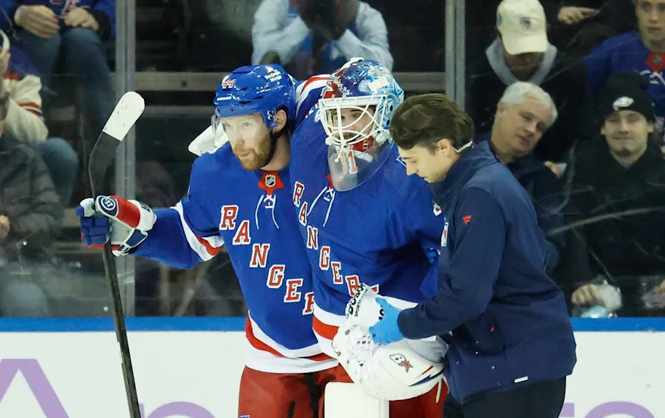New York Rangers goaltender Igor Shesterkin is helped off the ice by a trainer and New York Rangers defenseman Vladislav Gavrikov after falling back on his leg in the first period at Madison Square Garden in Manhattan, New York, Monday, January 05, 2026. JASON SZENES/ NY POST