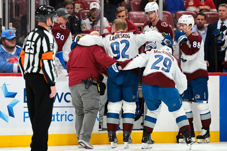 Colorado Avalanche left wing Gabriel Landeskog (92) is helped by center Nathan MacKinnon (29) to get off the ice after an injury.Sam Navarro-Imagn Images