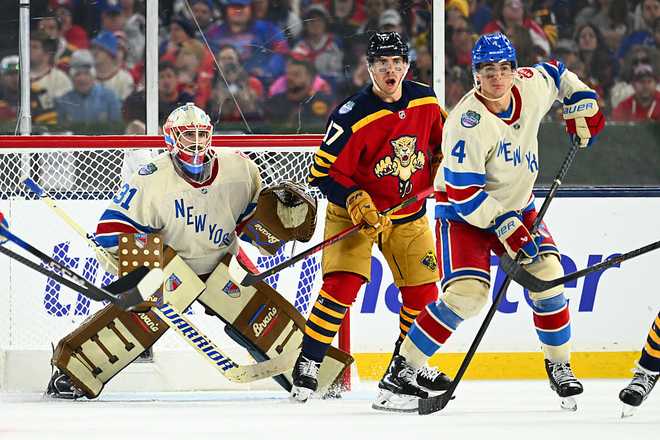 MIAMI, FLORIDA - JANUARY 02: Igor Shesterkin #31 of the New York Rangers, Evan Rodrigues #17 of the Florida Panthers and Braden Schneider #4 of the New York Rangers look to the puck during the third period of the 2026 Discover NHL Winter Classic game between the New York Rangers and the Florida Panthers at loanDepot Park on January 02, 2026 in Miami, Florida. (Photo by Ben Jackson/NHLI via Getty Images)