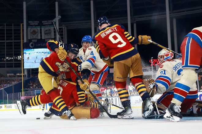 MIAMI, FLORIDA - JANUARY 02:  Brad Marchand #63 of the Florida Panthers battle for the puck against Braden Schneider #4 of the New York Rangers during the third period in the 2026 Discover NHL Winter Classic at loanDepot park on January 02, 2026 in Miami, Florida. (Photo by Carmen Mandato/Getty Images)