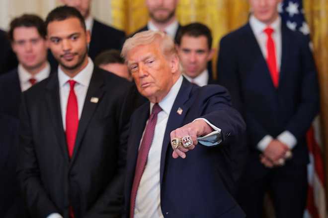 WASHINGTON, DC - JANUARY 15: U.S. President Donald Trump holds up his fist to show two Stanley Cup rings presented to him by the 2025 Stanley Cup Champion Florida Panthers in the East Room of the White House on January 15, 2026 in Washington, DC. The Florida Panthers defeated the Edmonton Oilers for the second straight year in their first-ever championships since joining the NHL in 1993. (Photo by Anna Moneymaker/Getty Images)
