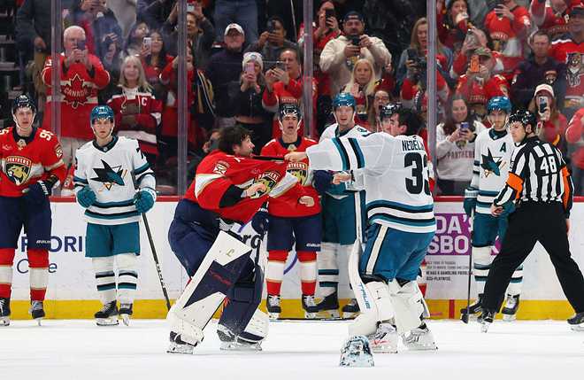 SUNRISE, FLORIDA - JANUARY 19: Alex Nedeljkovic #33 of thea San Jose Sharks and Sergei Bobrovsky #72 of the Florida Panthers fight during the third period at Amerant Bank Arena on January 19, 2026 in Sunrise, Florida. (Photo by Bruce Bennett/Getty Images)