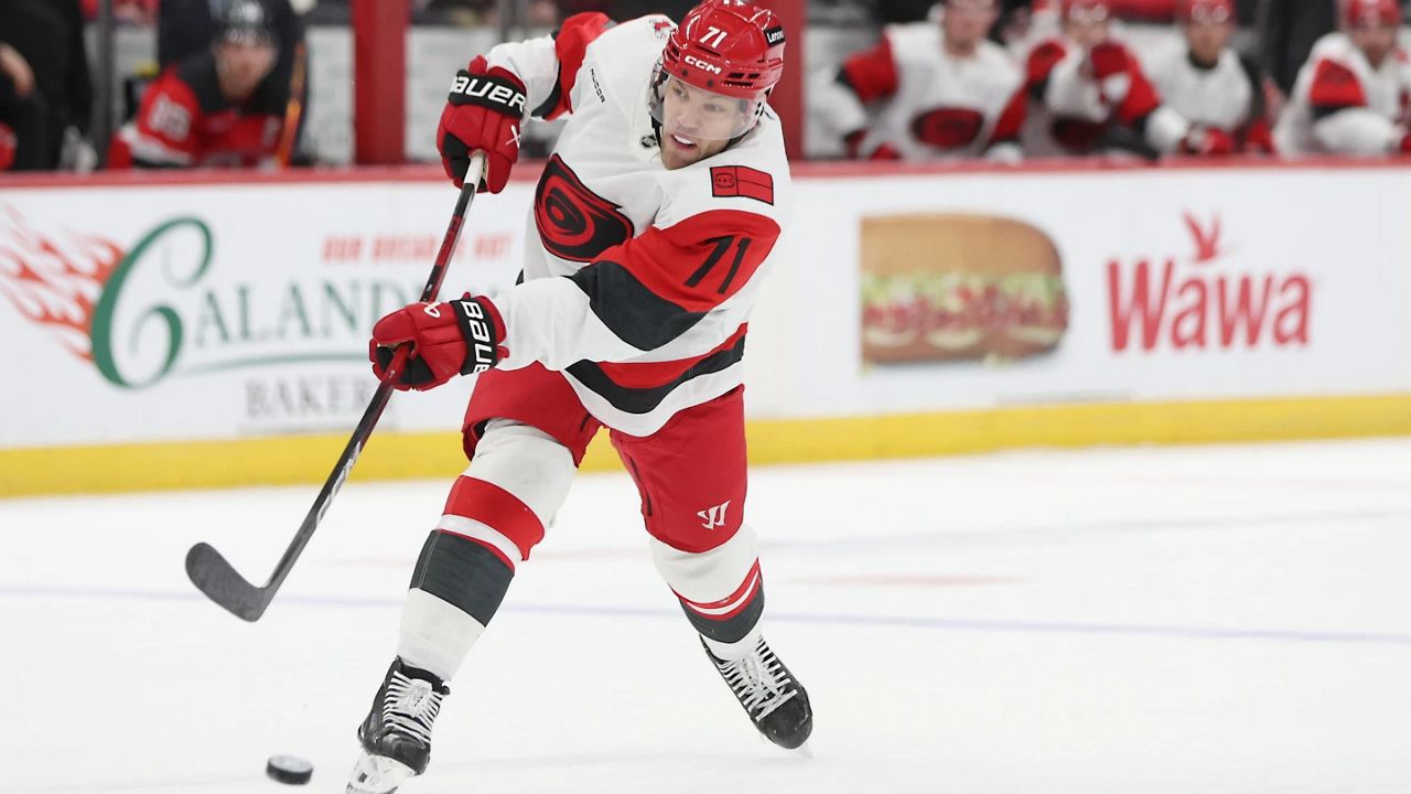 Carolina Hurricanes left wing Taylor Hall takes a shot in the first period of an NHL hockey game against the New Jersey Devils, Sunday, Jan. 4, 2026, in Newark, N.J. (AP Photo/Heather Khalifa)