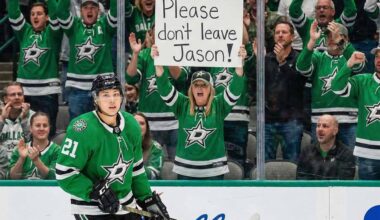 Dallas Stars forward Jason Robertson skates on the ice while a female fan behind the glass holds a handwritten sign that reads, 'Please don't leave Jason!'.