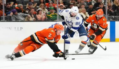 Anaheim Ducks defenseman Jackson Lacombe, left, falls as he tries to pass the puck while under pressure from Tampa Bay Lightning right wing Nikita Kucherov, center as left wing Alex Killorn skates behind during the second period of an NHL hockey game Wednesday, Dec. 31, 2025, in Anaheim, Calif. (AP Photo/Mark J. Terrill)