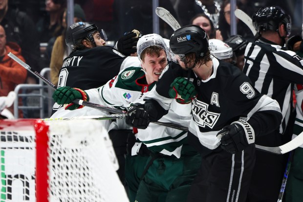 Minnesota Wild right wing Danila Yurov, front right, and Los Angeles Kings right wing Adrian Kempe (9) fight as defenseman Drew Doughty, back left, and additional players fight during the second period of an NHL hockey game, Monday, Jan. 5, 2026, in Los Angeles. (AP Photo/Jessie Alcheh)