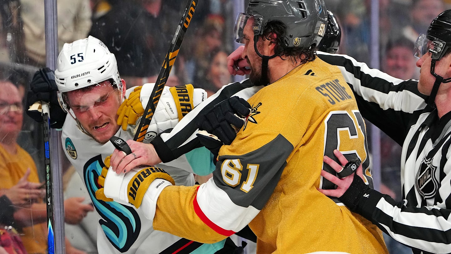 Jan 31, 2026; Las Vegas, Nevada, USA; Vegas Golden Knights right wing Mark Stone (61) grabs Seattle Kraken defenseman Ryan Lindgren (55) during the third period at T-Mobile Arena. Mandatory Credit: Stephen R. Sylvanie-Imagn Images