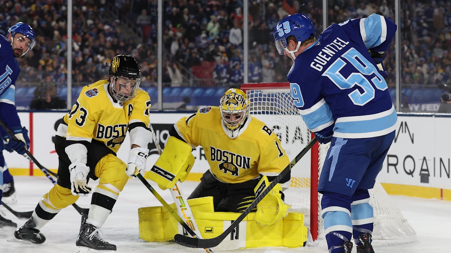 Feb 1, 2026; Tampa Bay, Florida, USA; Tampa Bay Lightning center Jake Guentzel (59) shoots the puck as Boston Bruins goaltender Jeremy Swayman (1) and defenseman Charlie McAvoy (73) defend during the second period in the 2026 Stadium Series ice hockey game at Raymond James Stadium. Mandatory Credit: Kim Klement Neitzel-Imagn Images