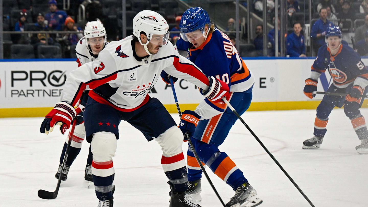 Nov 30, 2025; Elmont, New York, USA;  Washington Capitals defenseman Matt Roy (3) blocks the shot by New York Islanders right wing Simon Holmstrom (10) during the second period at UBS Arena. Mandatory Credit: Dennis Schneidler-Imagn Images