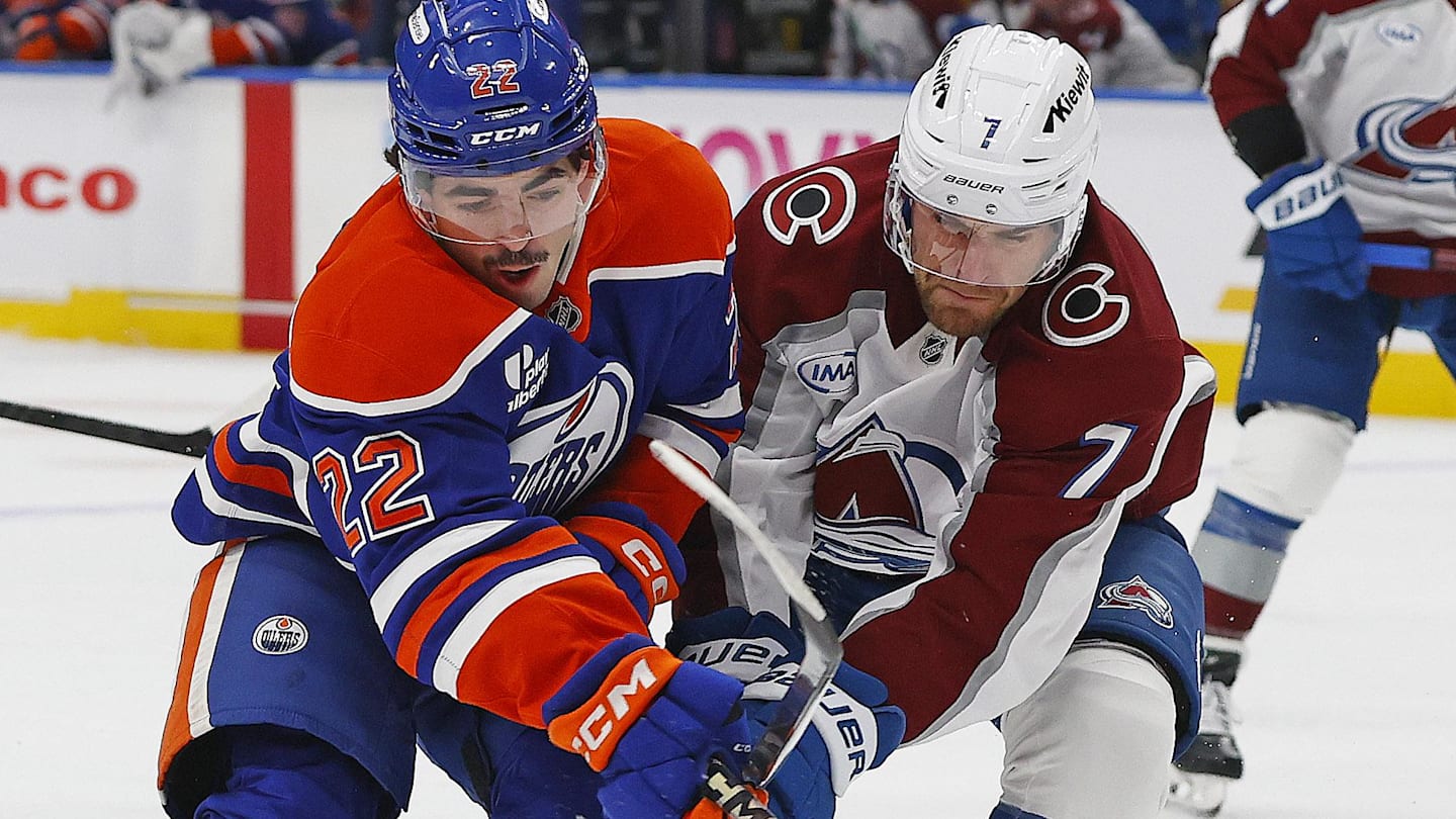 Nov 8, 2025; Edmonton, Alberta, CAN; Edmonton Oilers forward Matt Savoie (22) and Colorado Avalanche defensemen Devon Toews (7) battles for position during the first period at Rogers Place. Mandatory Credit: Perry Nelson-Imagn Images