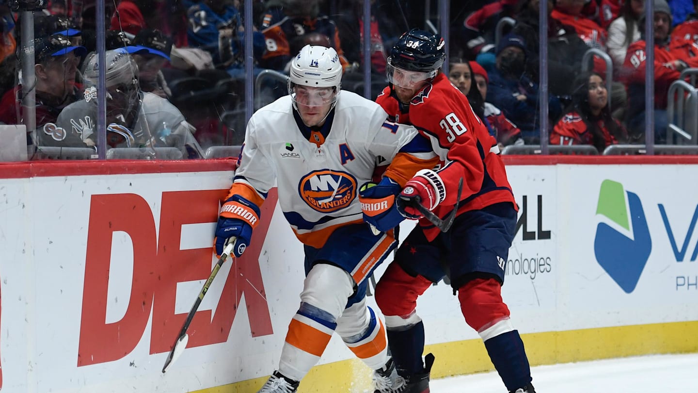 Feb 2, 2026; Washington, District of Columbia, USA; New York Islanders center Bo Horvat (14) controls the puck defended by Washington Capitals defenseman Rasmus Sandin (38) during the third period at Capital One Arena. Mandatory Credit: Hannah Foslien-Imagn Images