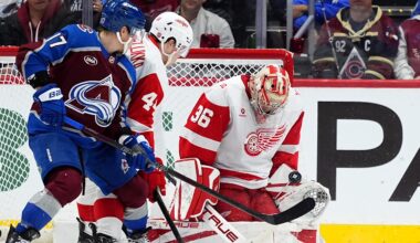 Feb 2, 2026; Denver, Colorado, USA; Detroit Red Wings goaltender John Gibson (36) makes a save next to defenseman Axel Sandin-Pellikka (44) and Colorado Avalanche center Parker Kelly (17) in the first period at Ball Arena. Mandatory Credit: Ron Chenoy-Imagn Images