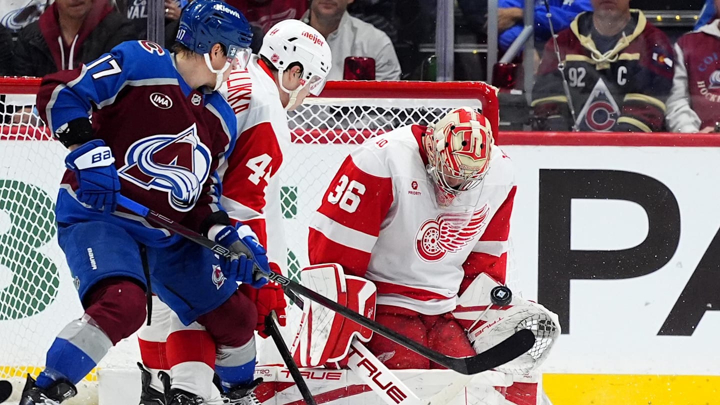Feb 2, 2026; Denver, Colorado, USA; Detroit Red Wings goaltender John Gibson (36) makes a save next to defenseman Axel Sandin-Pellikka (44) and Colorado Avalanche center Parker Kelly (17) in the first period at Ball Arena. Mandatory Credit: Ron Chenoy-Imagn Images