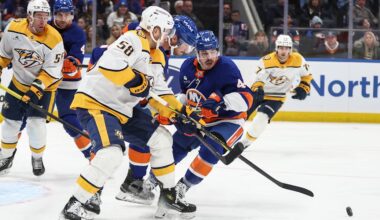 Jan 31, 2026; Elmont, New York, USA;  Nashville Predators left wing Michael Bunting (58) battles for control of the puck with New York Islanders defenseman Scott Mayfield (24) and center Jean-Gabriel Pageau (44) in the third period at UBS Arena. Mandatory Credit: Wendell Cruz-Imagn Images