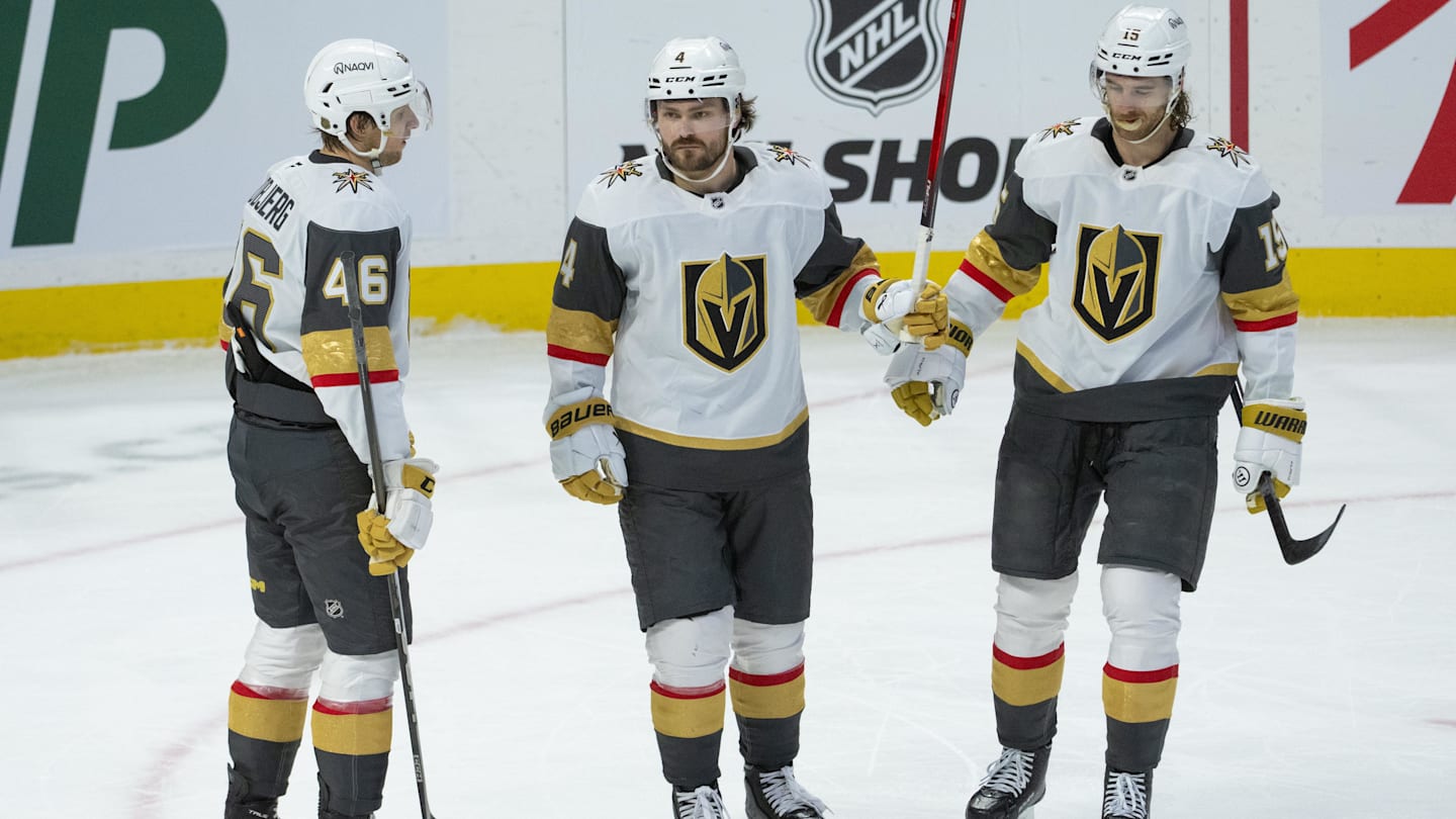 Jan 25, 2026; Ottawa, Ontario, CAN; Vegas Golden Knights defenseman Rasmus Anderssson (4 - center) celebrates with right wing Jonas Rondbjerg (46) and defenseman Noah Hanifin (15) his goal scored in the third period against the Ottawa Senators at the Canadian Tire Centre. Mandatory Credit: Marc DesRosiers-IMAGN Images