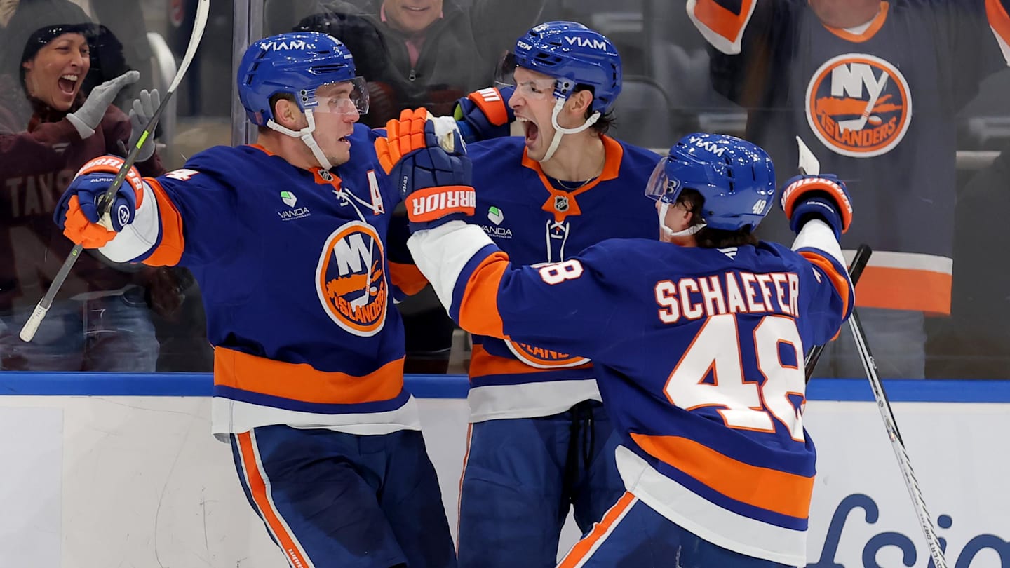 Feb 3, 2026; Elmont, New York, USA; New York Islanders center Bo Horvat (14) celebrates his game winning overtime goal against the Pittsburgh Penguins with center Mathew Barzal (13) and defenseman Matthew Schaefer (48) at UBS Arena. Mandatory Credit: Brad Penner-Imagn Images