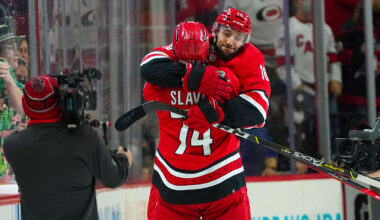 Jan 25, 2022; Raleigh, North Carolina, USA;  Carolina Hurricanes center Vincent Trocheck (16) and defenseman Jaccob Slavin (74) celebrate their victory against the Vegas Golden Knights at PNC Arena. Mandatory Credit: James Guillory-Imagn Images