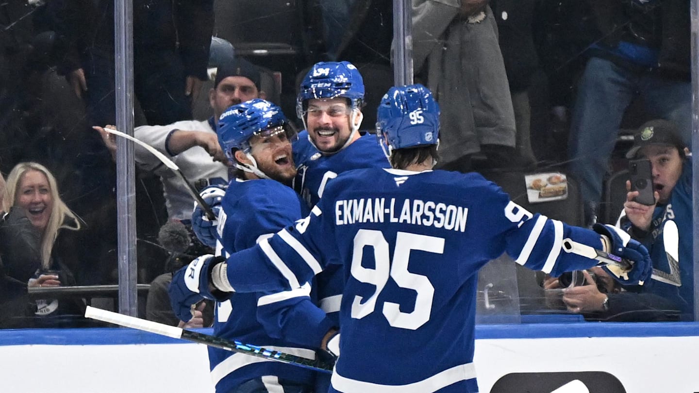 Oct 16, 2025; Toronto, Ontario, CAN; Toronto Maple Leafs forward Auston Matthews (34) celebrates with forward William Nylander (88) and defenseman Oliver Ekman-Larsson (95) after scoring the winning goal against the New York Rangers in overtime at Scotiabank Arena. Mandatory Credit: Dan Hamilton-Imagn Images