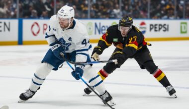 Jan 31, 2026; Vancouver, British Columbia, CAN; Vancouver Canucks forward Jonathan Lekkerimaki (23) stick checks Toronto Maple Leafs defenseman Morgan Rielly (44) in the first period at Rogers Arena. Mandatory Credit: Bob Frid-Imagn Images