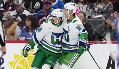 Oct 23, 2025; Denver, Colorado, USA; Carolina Hurricanes center Seth Jarvis (24) celebrates his goal with defenseman Mike Reilly (6) and center Sebastian Aho (20) in the first period against the Colorado Avalanche at Ball Arena. Mandatory Credit: Ron Chenoy-Imagn Images