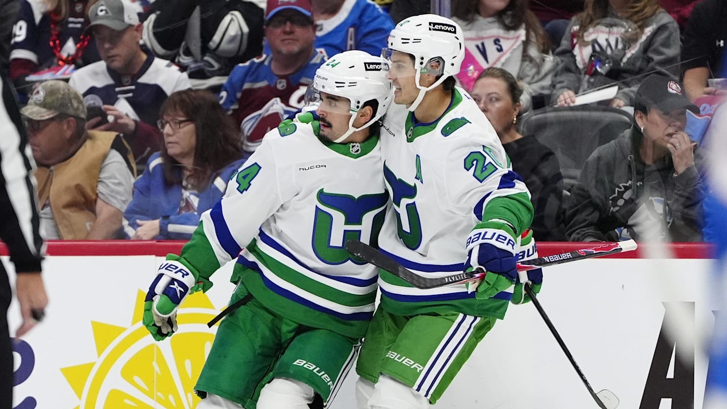 Oct 23, 2025; Denver, Colorado, USA; Carolina Hurricanes center Seth Jarvis (24) celebrates his goal with defenseman Mike Reilly (6) and center Sebastian Aho (20) in the first period against the Colorado Avalanche at Ball Arena. Mandatory Credit: Ron Chenoy-Imagn Images