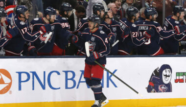Cole Sillinger celebrates a goal with the Blue Jackets bench.