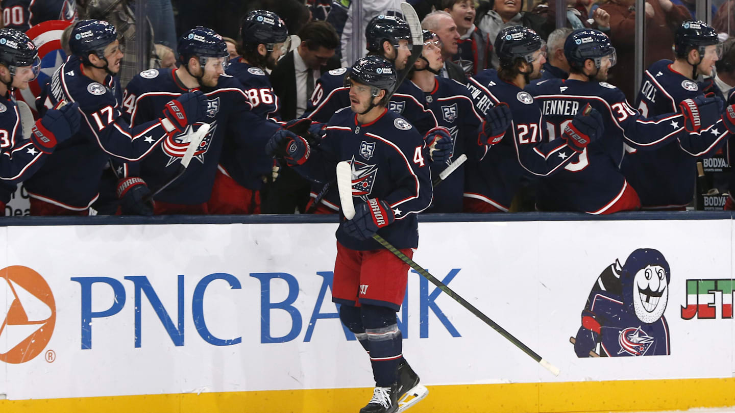 Cole Sillinger celebrates a goal with the Blue Jackets bench.