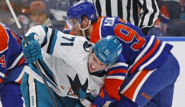 Jan 29, 2026; Edmonton, Alberta, CAN; San Jose Sharks forward Macklin Celebrini (71) and Edmonton Oilers forward Connor McDavid (97) battle for a loose puck during the second period at Rogers Place. Mandatory Credit: Perry Nelson-Imagn Images