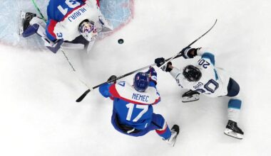 [US, Mexico & Canada customers only] Feb 11, 2026; Milan, Italy; Samuel Hlavaj and Simon Nemec of Slovakia in action with Sebastian Aho of Finland  in men's ice hockey group B play during the Milano Cortina 2026 Olympic Winter Games at Milano Santagiulia Ice Hockey Arena. Mandatory Credit: David W Cerny/Reuters via Imagn Images