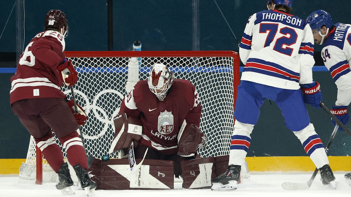 Team Latvia and Columbus Blue Jackets goaltender Elvis Merzlikins makes a save against team USA.