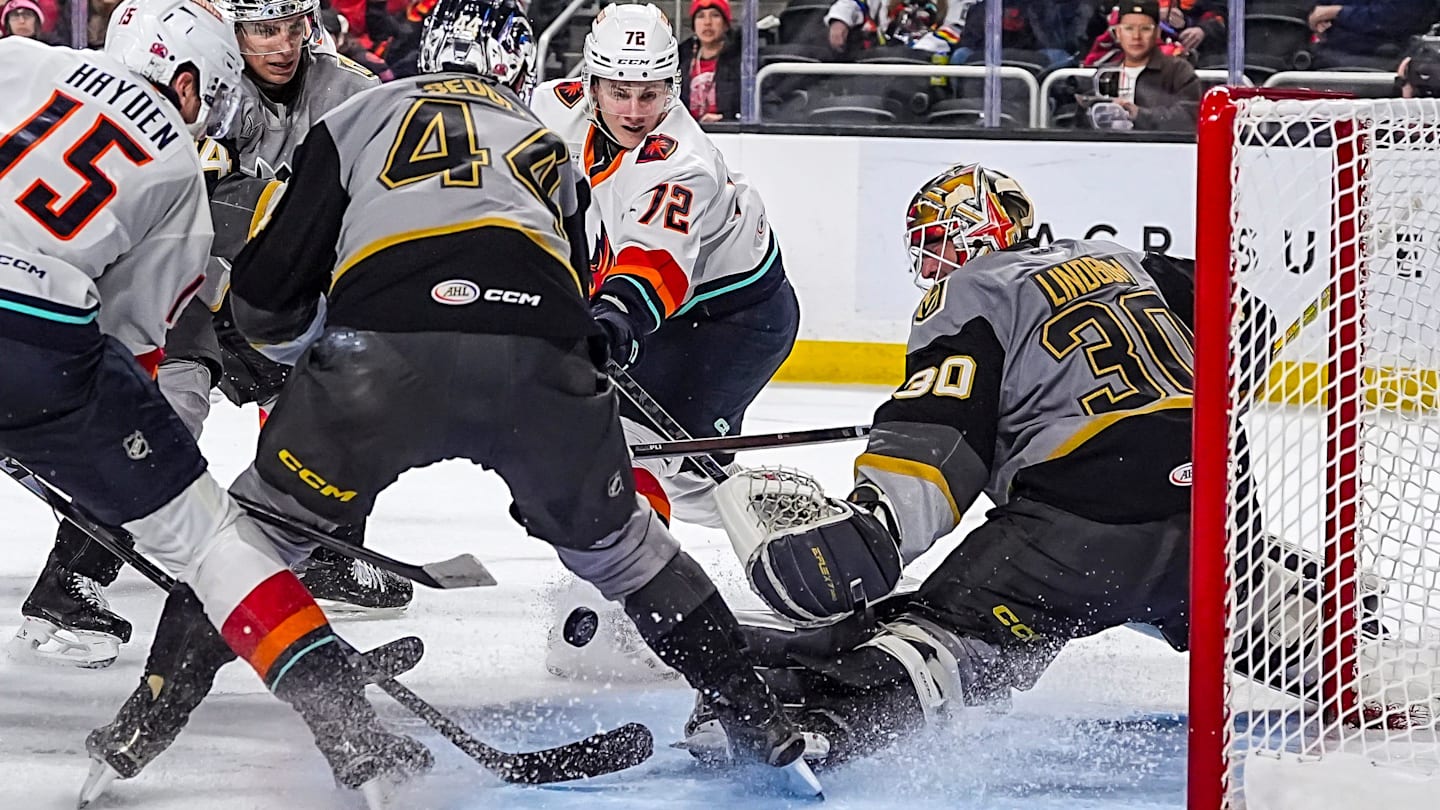 Coachella Valley Firebirds center Andrei Loshko makes an unsuccessful attempt on the goal as Henderson Silver Knights goalie Carl Lindbom gets low to protect the net during the second period of their game at Acrisure Arena in Palm Desert, Calif., Wednesday, Jan. 7, 2026.