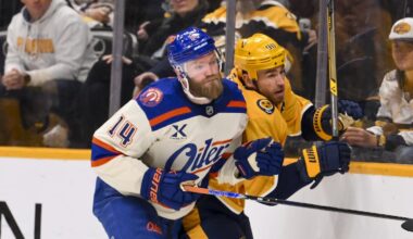 Jan 13, 2026; Nashville, Tennessee, USA;  Edmonton Oilers defenseman Mattias Ekholm (14) checks Nashville Predators center Ryan O'Reilly (90) during the third period at Bridgestone Arena. Mandatory Credit: Steve Roberts-Imagn Images