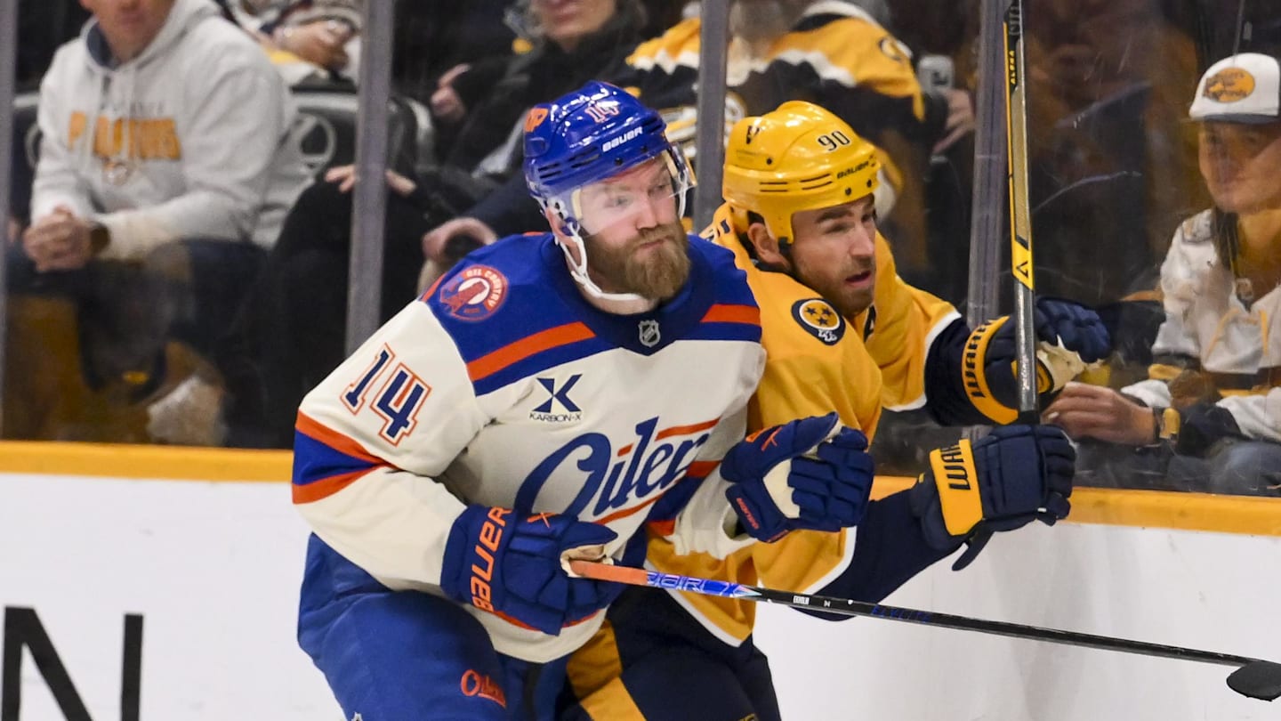 Jan 13, 2026; Nashville, Tennessee, USA;  Edmonton Oilers defenseman Mattias Ekholm (14) checks Nashville Predators center Ryan O'Reilly (90) during the third period at Bridgestone Arena. Mandatory Credit: Steve Roberts-Imagn Images