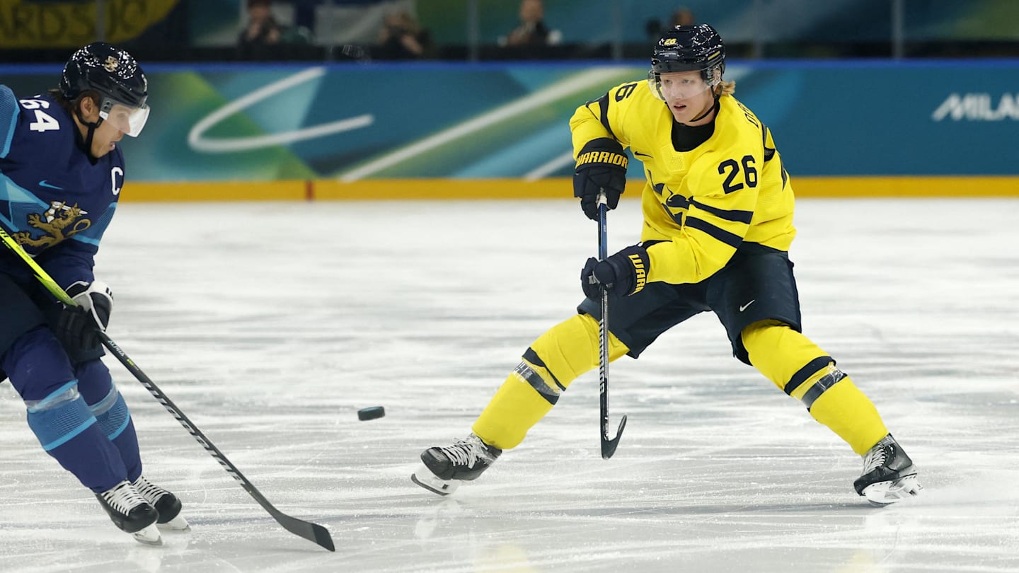 Feb 13, 2026; Milan, Italy; Mikael Granlund of Finland in action with Rasmus Dahlin of Sweden in men's ice hockey group B play during the Milano Cortina 2026 Olympic Winter Games at Milano Santagiulia Ice Hockey Arena. Mandatory Credit: Geoff Burke-Imagn Images