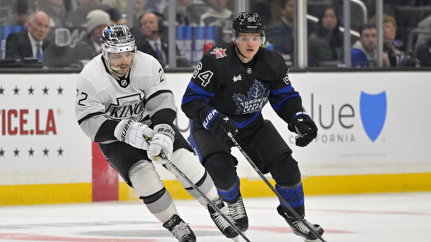 Jan 2, 2024; Los Angeles, California, USA; Los Angeles Kings left wing Kevin Fiala (22) skates the puck past Toronto Maple Leafs center David Kampf (64) in the second period at Crypto.com Arena. Mandatory Credit: Jayne Kamin-Oncea-Imagn Images