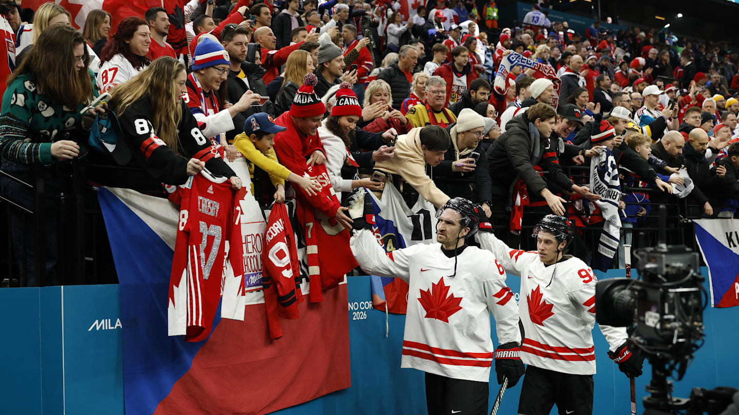 Feb 12, 2026; Milan, Italy; Mitch Marner and Mark Stone of Canada celebrate with fans after the match against Czechia  in a men's ice hockey group A match during the Milano Cortina 2026 Olympic Winter Games at Milano Santagiulia Ice Hockey Arena. Mandatory Credit: Geoff Burke-Imagn Images