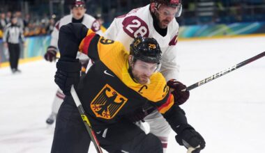 Feb 14, 2026; Milan, Italy; Leon Draisaitl of Germany in action with Zemgus Girgensons of Latvi during a Group C men's ice hockey game during the Milano Cortina 2026 Olympic Winter Games at Milano Rho Ice Hockey Arena. Mandatory Credit: Amber Searls-Imagn Images