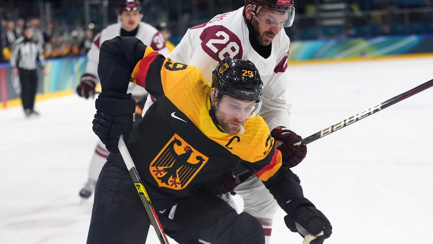 Feb 14, 2026; Milan, Italy; Leon Draisaitl of Germany in action with Zemgus Girgensons of Latvi during a Group C men's ice hockey game during the Milano Cortina 2026 Olympic Winter Games at Milano Rho Ice Hockey Arena. Mandatory Credit: Amber Searls-Imagn Images