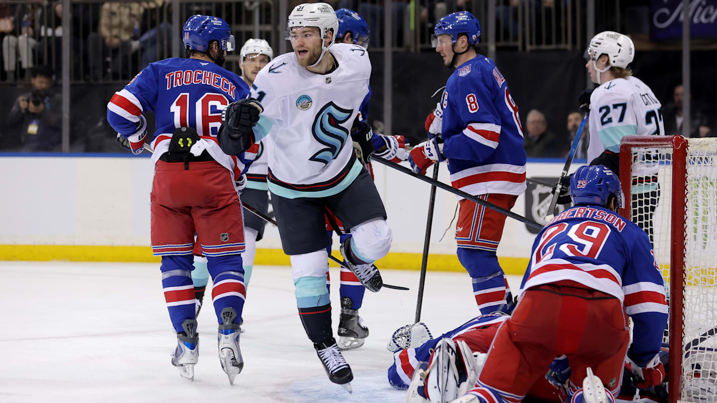 Jan 12, 2026; New York, New York, USA; Seattle Kraken center Shane Wright (51) celebrates his goal against New York Rangers goaltender Jonathan Quick (32) and defenseman Matthew Robertson (29) during the third period at Madison Square Garden. Mandatory Credit: Brad Penner-Imagn Images