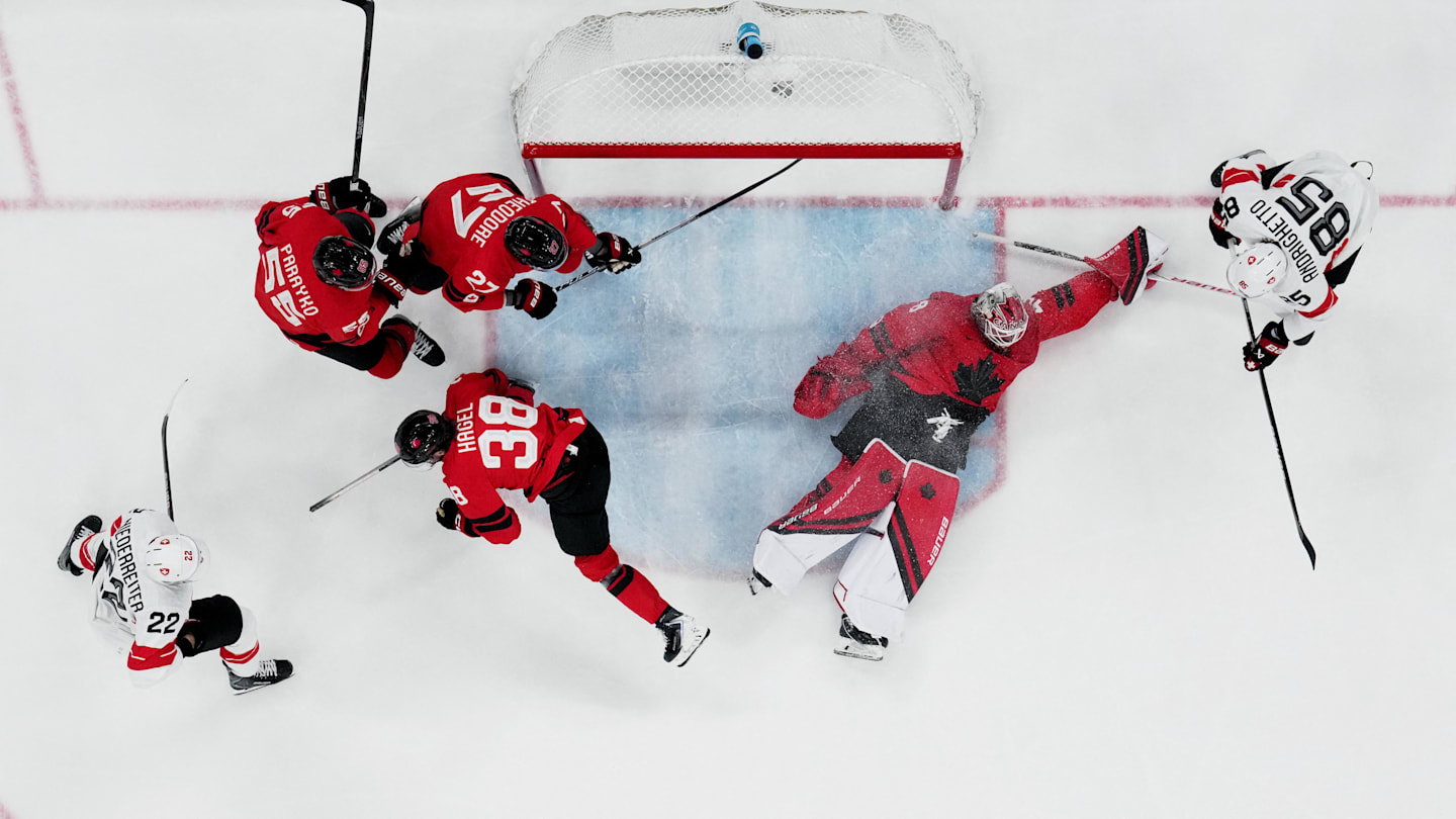 [US, Mexico & Canada customers only] Feb 13, 2026; Milan, Italy; Logan Thompson, Colton Parayko, Brandon Hagel and Shea Theodore of Canada in action with Nino Niederreiter and Sven Andrighetto of Switzerland in men's ice hockey group A play during the Milano Cortina 2026 Olympic Winter Games at Milano Santagiulia Ice Hockey Arena. Mandatory Credit: Marton Monus/Reuters via Imagn Images