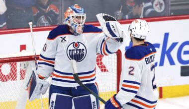 Dec 29, 2025; Winnipeg, Manitoba, CAN; Edmonton Oilers goaltender Calvin Pickard (30) and Edmonton Oilers defenseman Evan Bouchard (2) celebrate their victory over the Winnipeg Jets at Canada Life Centre. Mandatory Credit: James Carey Lauder-Imagn Images