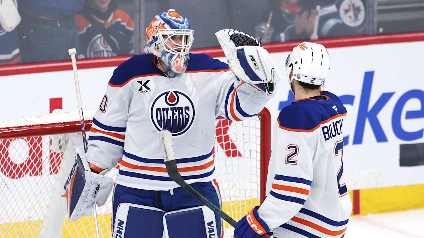Dec 29, 2025; Winnipeg, Manitoba, CAN; Edmonton Oilers goaltender Calvin Pickard (30) and Edmonton Oilers defenseman Evan Bouchard (2) celebrate their victory over the Winnipeg Jets at Canada Life Centre. Mandatory Credit: James Carey Lauder-Imagn Images